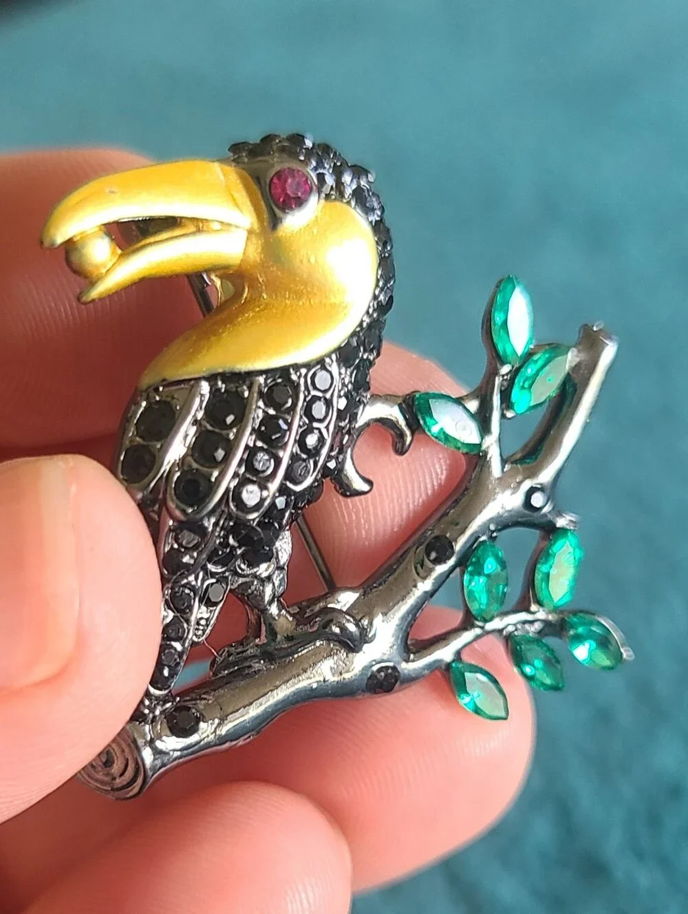 Vintage Gold-Accented Black Toucan Brooch with Green Leaves